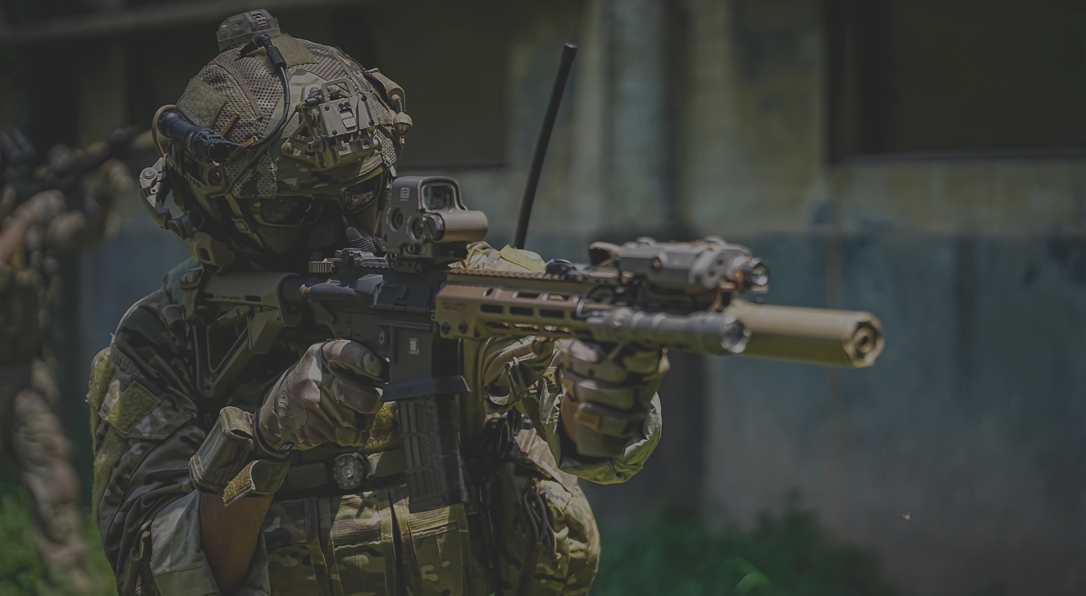 Person in police gear holding a rifle with a blurred background